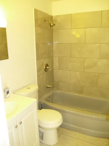 a bathroom with a toilet sink and shower