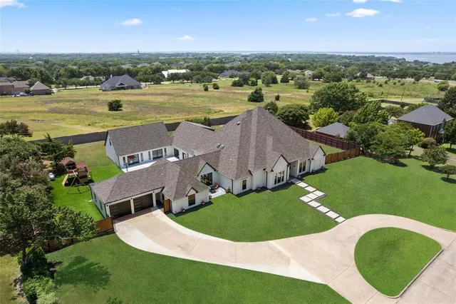an aerial view of residential houses with outdoor space and river