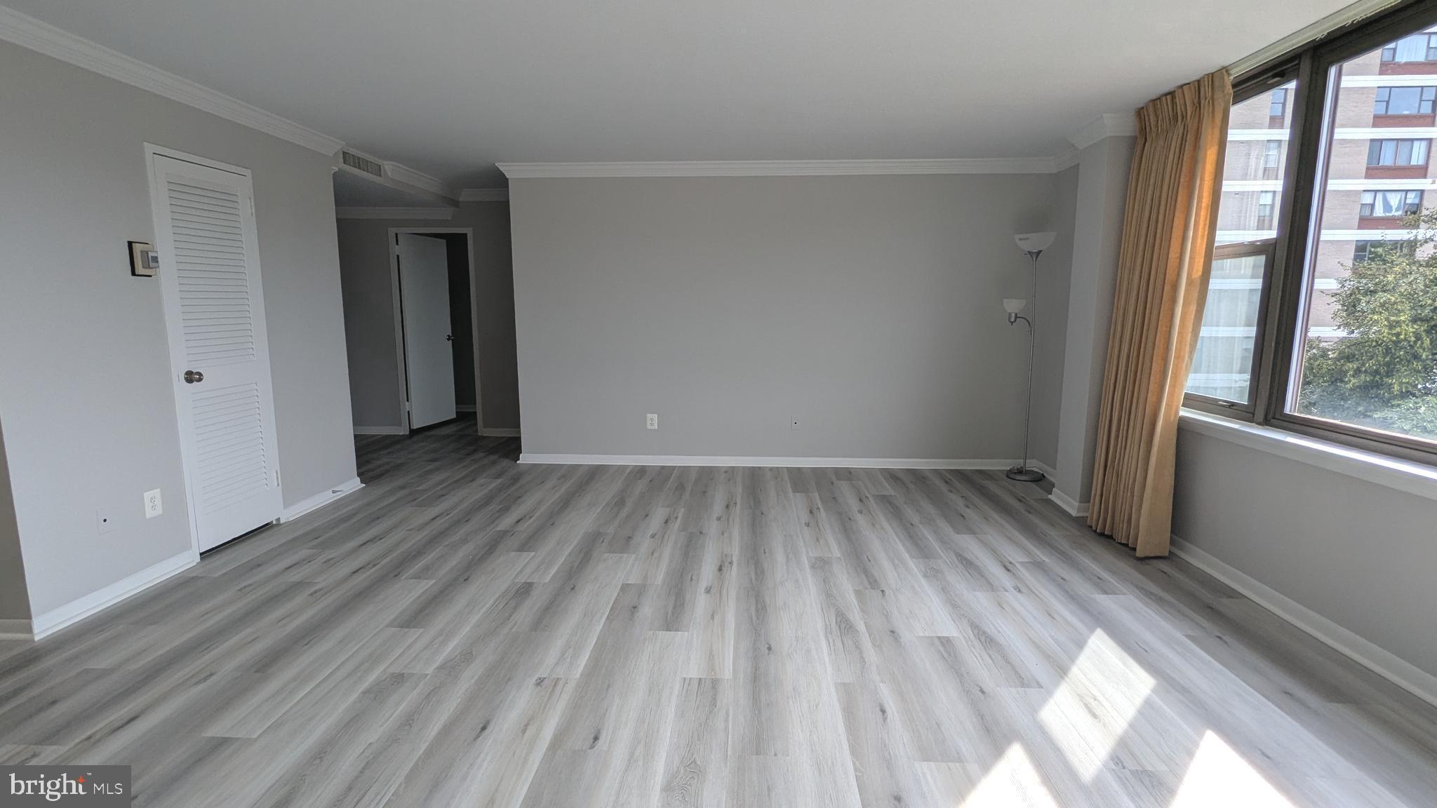 4600 Duke Street, Unit 620 Alexandria, VA 22304 - Photo 11 of 40 a view of a room with wooden floor and a window