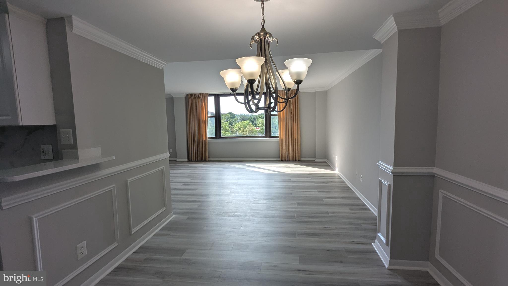 4600 Duke Street, Unit 620 Alexandria, VA 22304 - Photo 13 of 40 a view of an empty room with wooden floor and a window