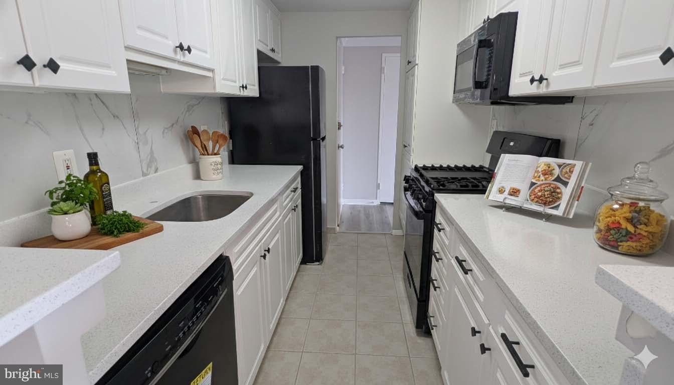4600 Duke Street, Unit 620 Alexandria, VA 22304 - Photo 15 of 40 a kitchen with stainless steel appliances granite countertop a sink a stove and a refrigerator