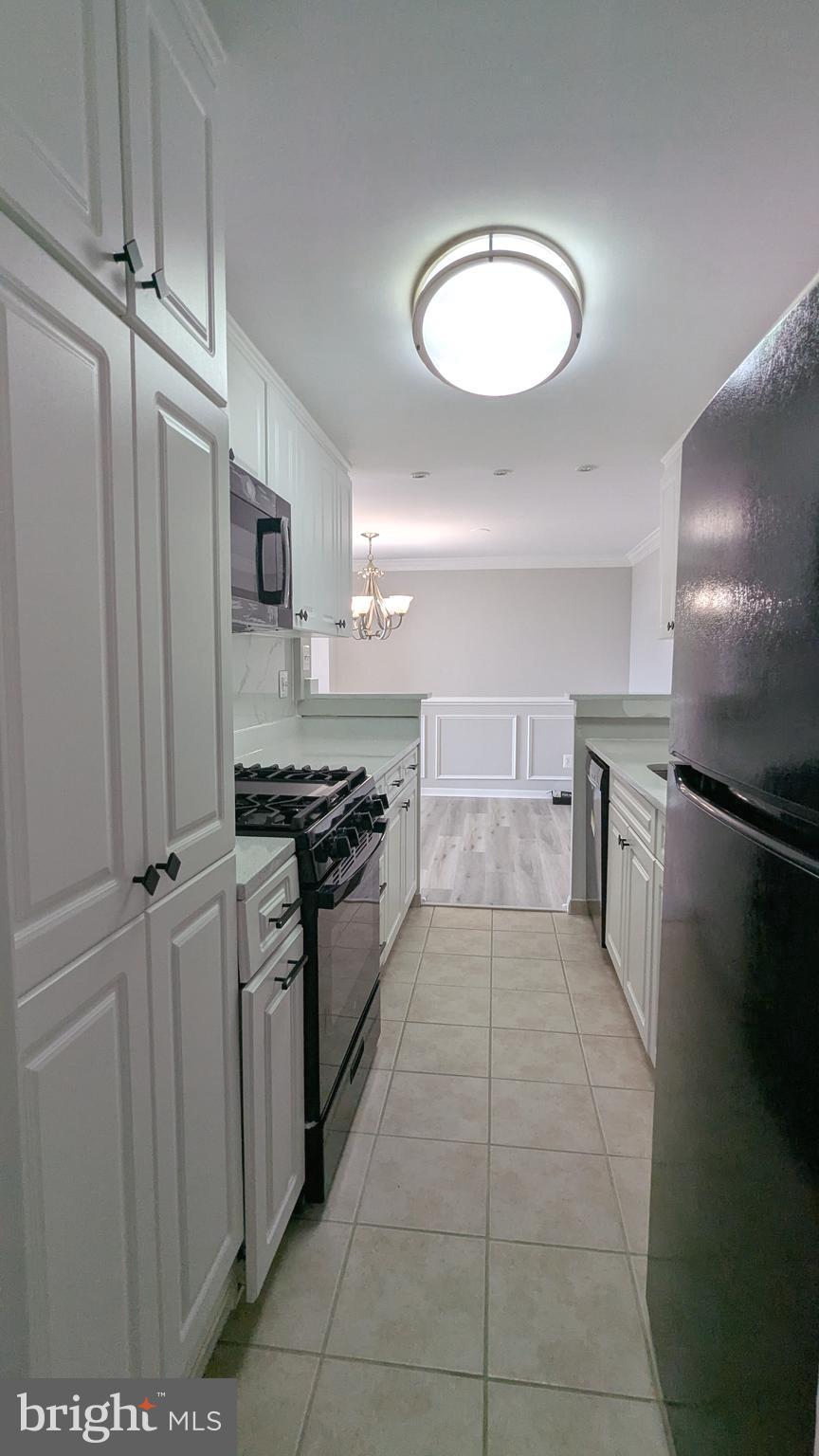 4600 Duke Street, Unit 620 Alexandria, VA 22304 - Photo 18 of 40 a large kitchen with cabinets and stainless steel appliances