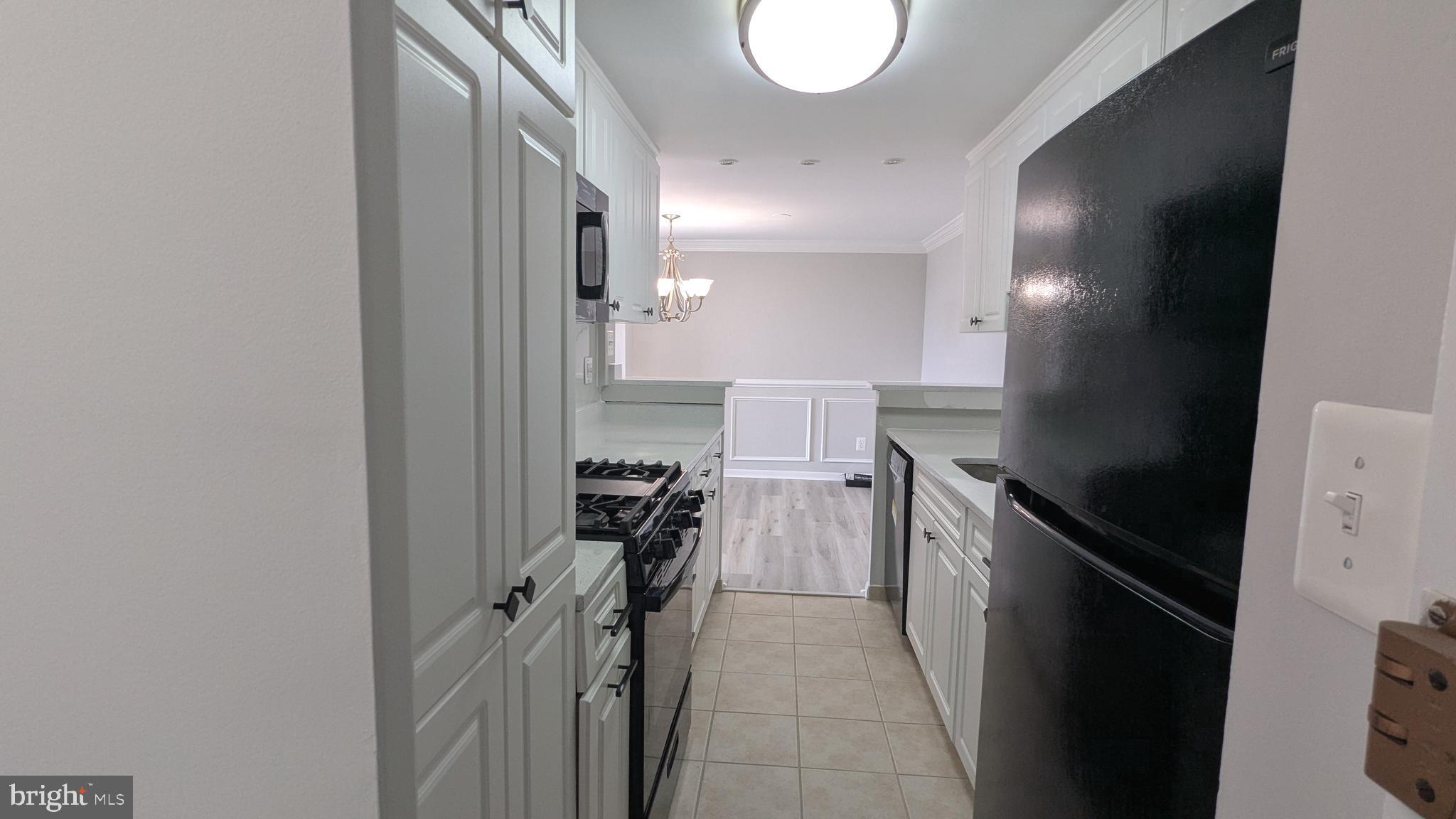 4600 Duke Street, Unit 620 Alexandria, VA 22304 - Photo 19 of 40 a kitchen with a sink and a stove top oven