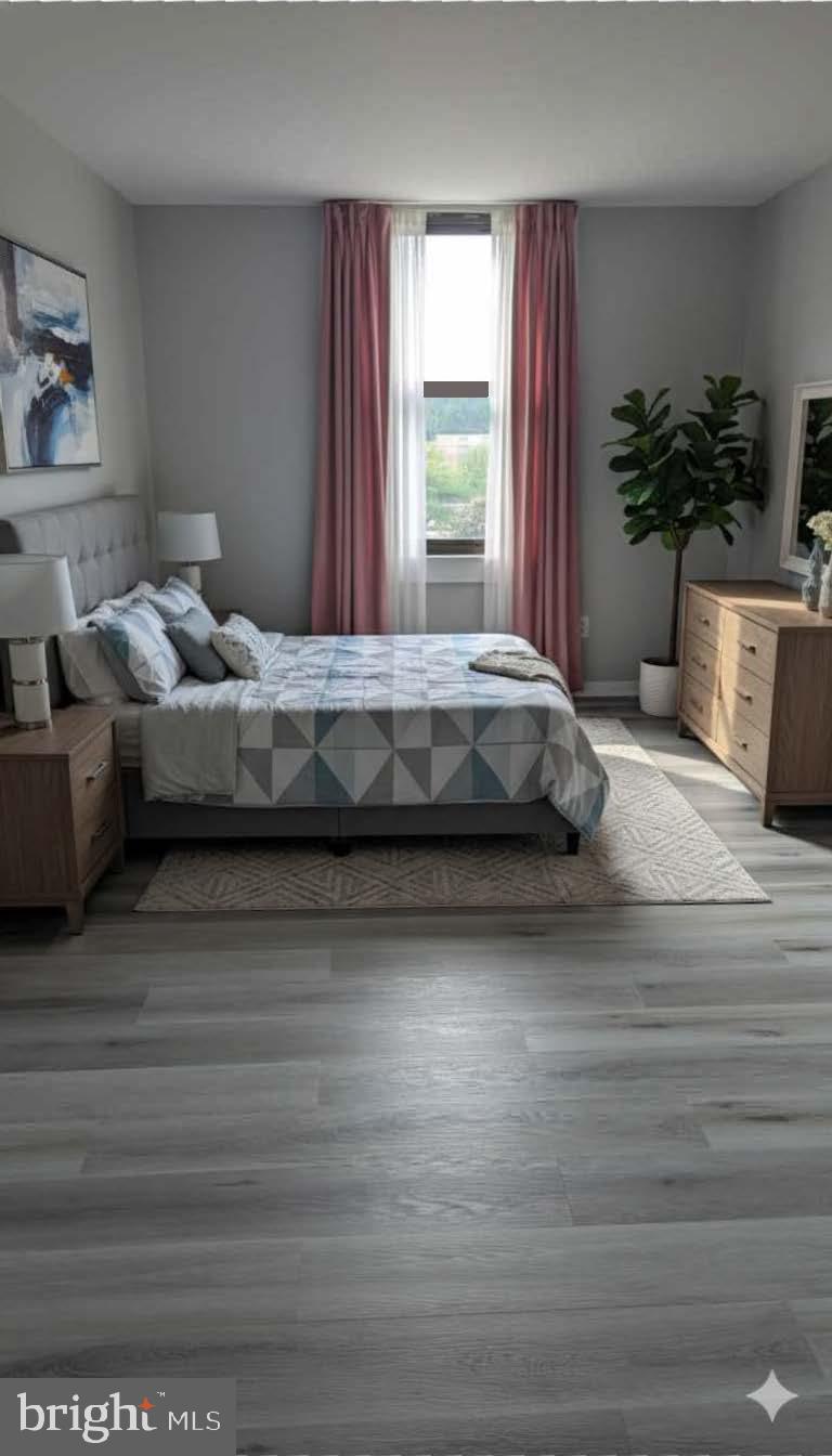 4600 Duke Street, Unit 620 Alexandria, VA 22304 - Photo 22 of 40 a spacious bedroom with a large bed and a potted plant