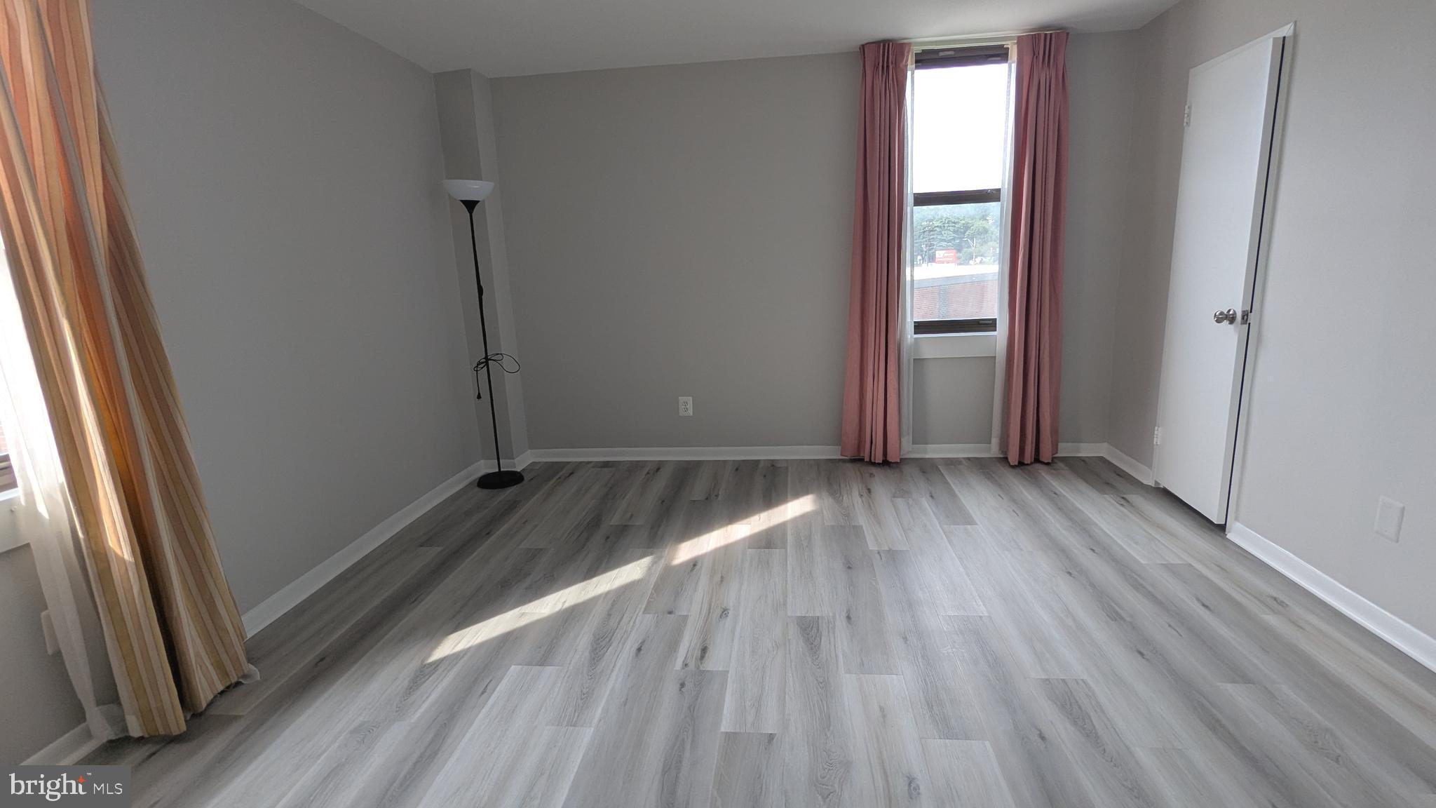 4600 Duke Street, Unit 620 Alexandria, VA 22304 - Photo 23 of 40 an empty room with wooden floor and windows