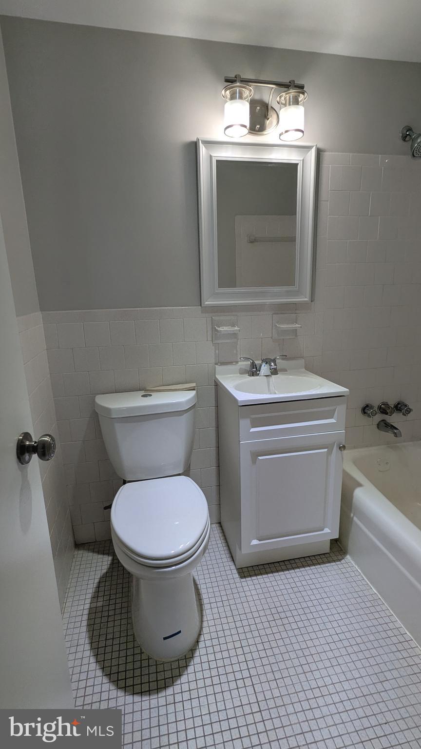 4600 Duke Street, Unit 620 Alexandria, VA 22304 - Photo 28 of 40 a bathroom with a sink toilet and a mirror