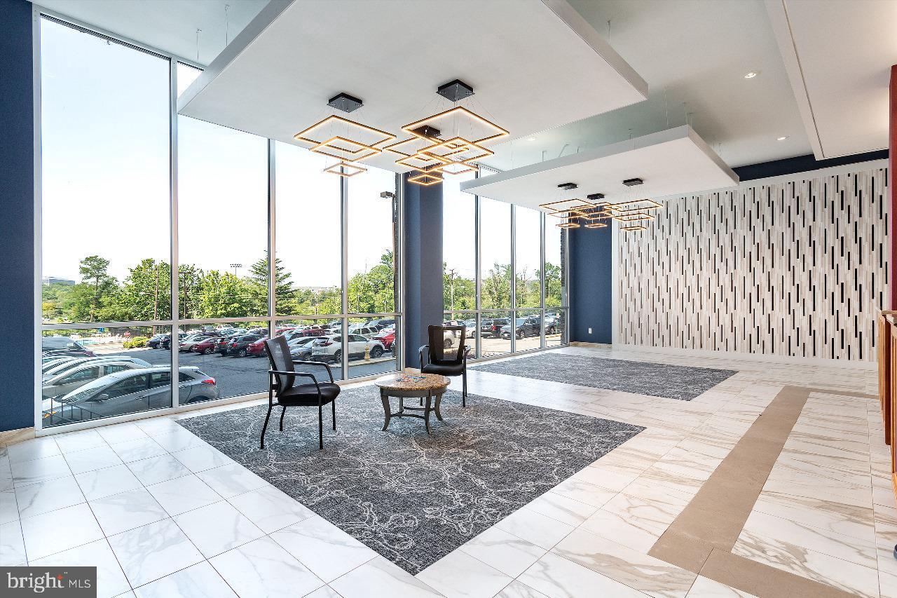 4600 Duke Street, Unit 620 Alexandria, VA 22304 - Photo 5 of 40 a living room with furniture and a large window