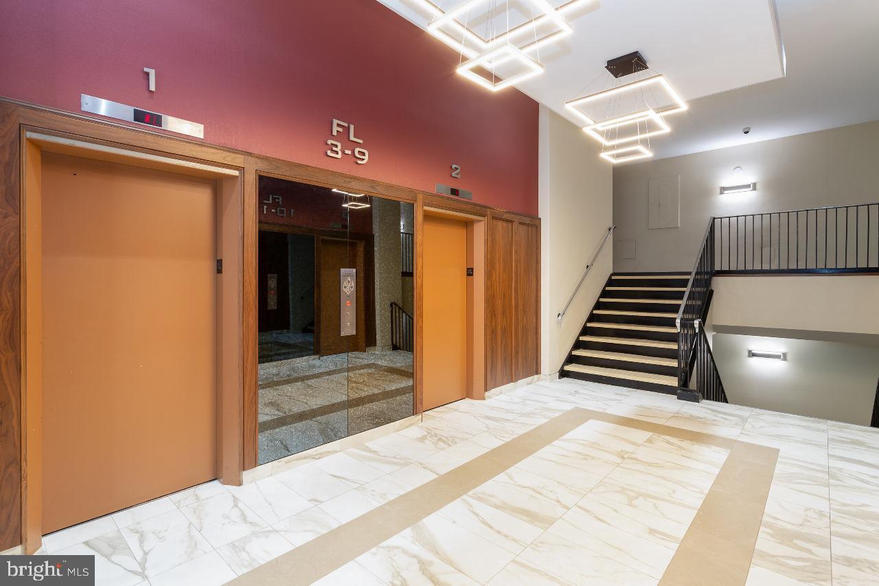 4600 Duke Street, Unit 620 Alexandria, VA 22304 - Photo 6 of 40 a view of a hallway with stairs and wooden floor