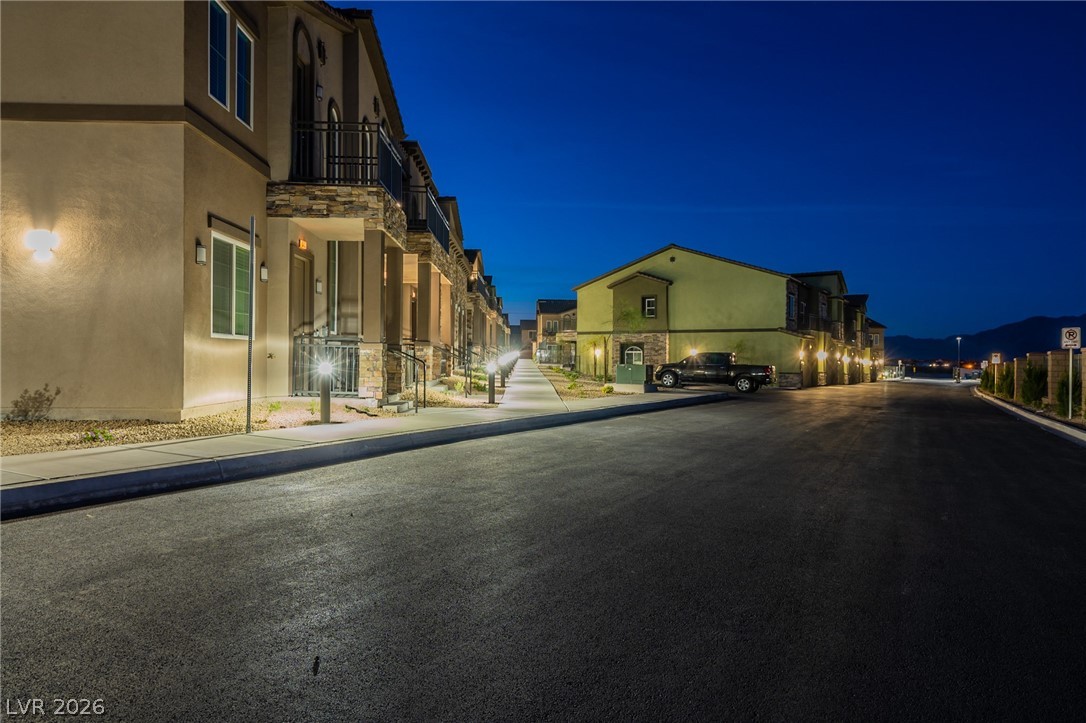 6444 Spring Jog Street Las Vegas, NV 89166 - Photo 3 of 13 These townhomes feature private balconies and a well-lit paved pathway.