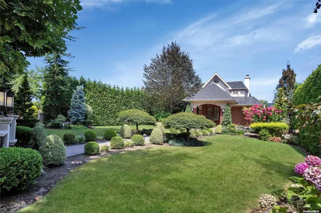 a front view of a house with a garden