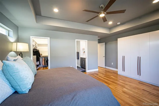 a bed room with a bed and a ceiling fan