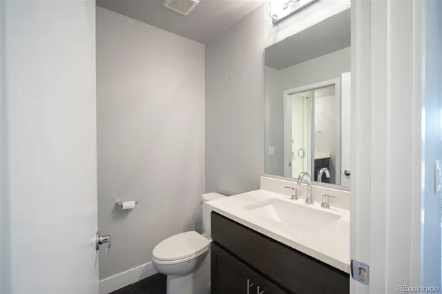 a bathroom with a sink toilet and a mirror