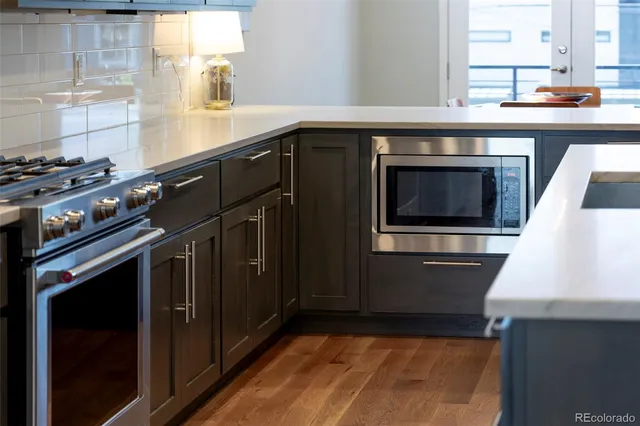 a kitchen with granite countertop a stove and a sink