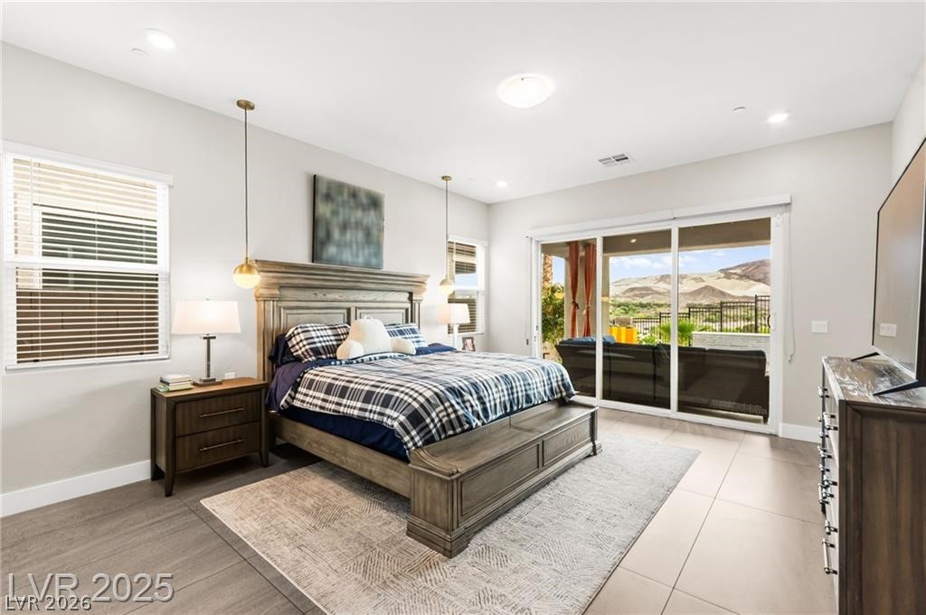 103 Reflection Cove Drive Henderson, NV 89011 - Photo 28 of 66 Bedroom featuring access to exterior, recessed lighting, and light tile patterned flooring