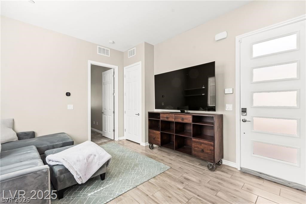 103 Reflection Cove Drive Henderson, NV 89011 - Photo 37 of 66 Living room with light wood-style floors and baseboards