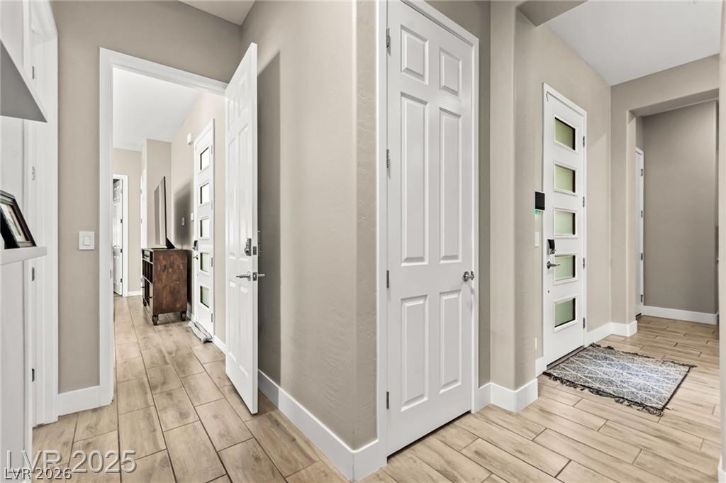 103 Reflection Cove Drive Henderson, NV 89011 - Photo 38 of 66 Hallway featuring wood finish floors and baseboards