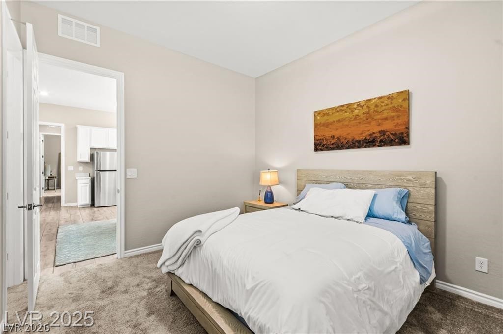 103 Reflection Cove Drive Henderson, NV 89011 - Photo 43 of 66 Carpeted bedroom featuring freestanding refrigerator and baseboards