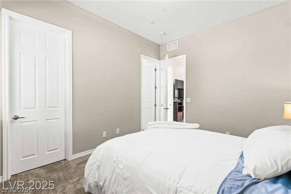 103 Reflection Cove Drive Henderson, NV 89011 - Photo 44 of 66 Carpeted bedroom featuring baseboards