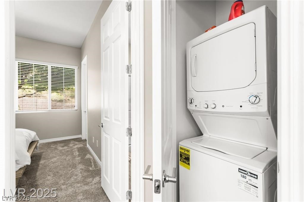 103 Reflection Cove Drive Henderson, NV 89011 - Photo 46 of 66 Washroom featuring stacked washer / drying machine and carpet floors