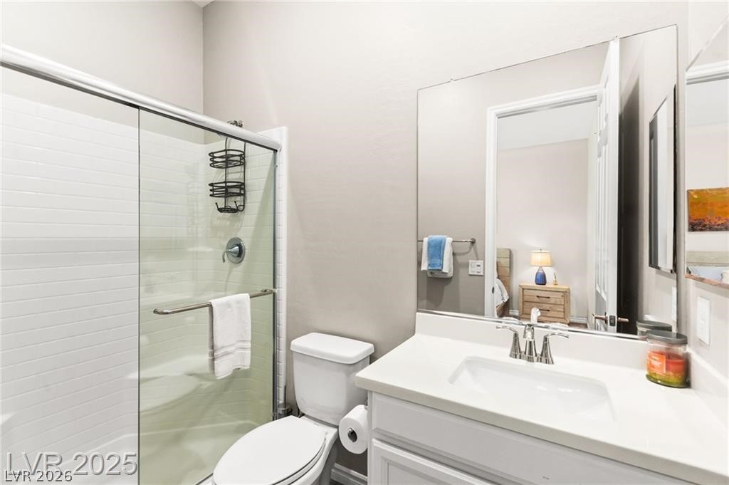 103 Reflection Cove Drive Henderson, NV 89011 - Photo 48 of 66 Bathroom featuring a stall shower, vanity, and ensuite bath