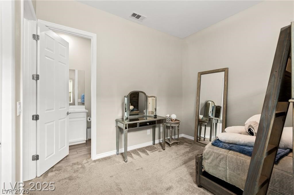 103 Reflection Cove Drive Henderson, NV 89011 - Photo 49 of 66 Living area featuring light carpet and baseboards