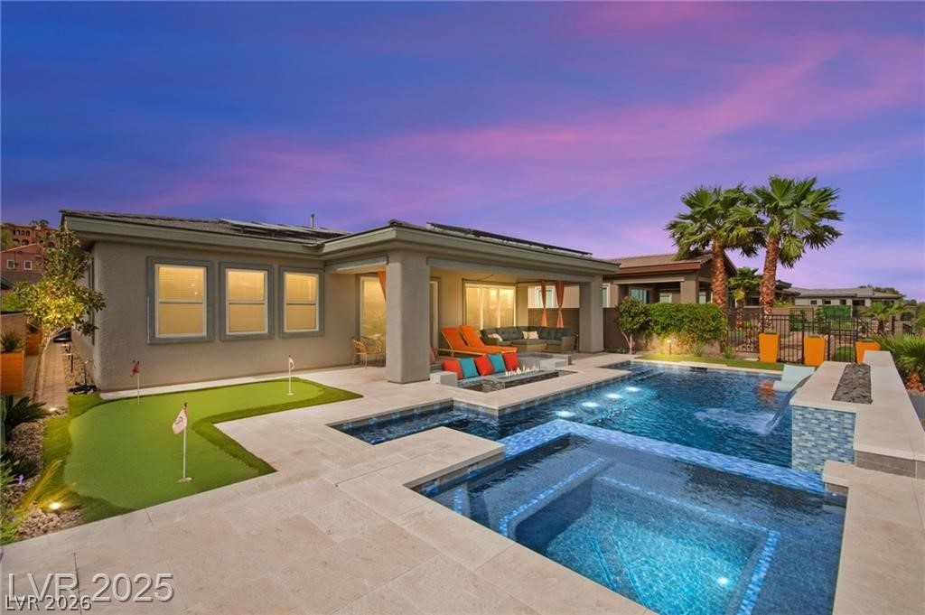 103 Reflection Cove Drive Henderson, NV 89011 - Photo 5 of 66 View of pool featuring a fenced backyard, a patio area, an area to practice putting, and a pool with connected hot tub