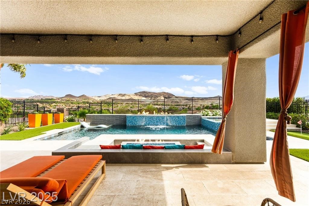 103 Reflection Cove Drive Henderson, NV 89011 - Photo 55 of 66 Fenced backyard featuring a patio area, an outdoor pool, and a mountain view