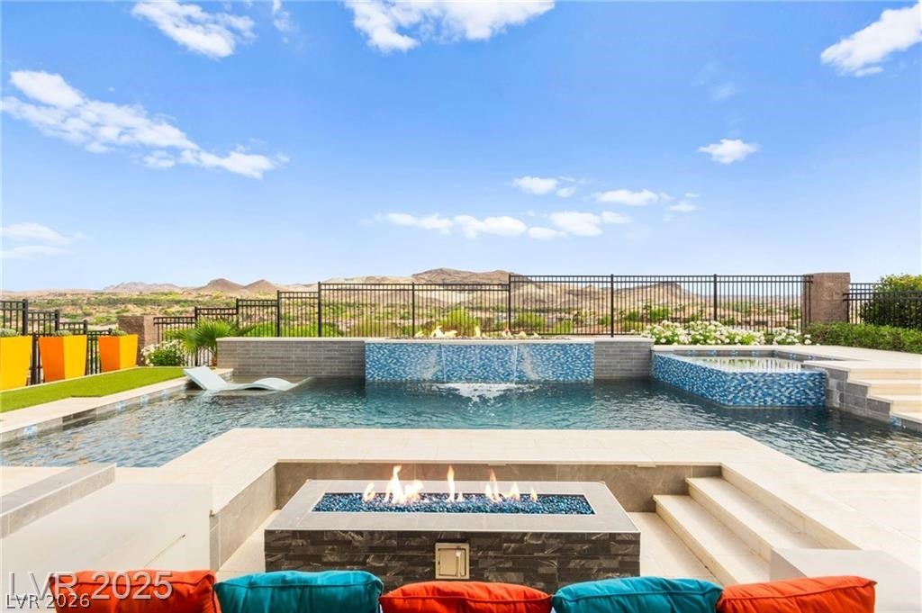 103 Reflection Cove Drive Henderson, NV 89011 - Photo 57 of 66 View of swimming pool featuring a patio, a fire pit, and a pool with connected hot tub
