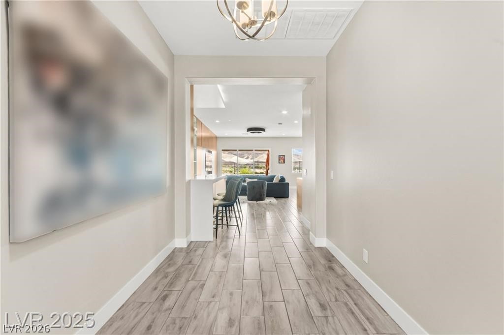 103 Reflection Cove Drive Henderson, NV 89011 - Photo 6 of 66 Hall featuring wood finish floors and a chandelier