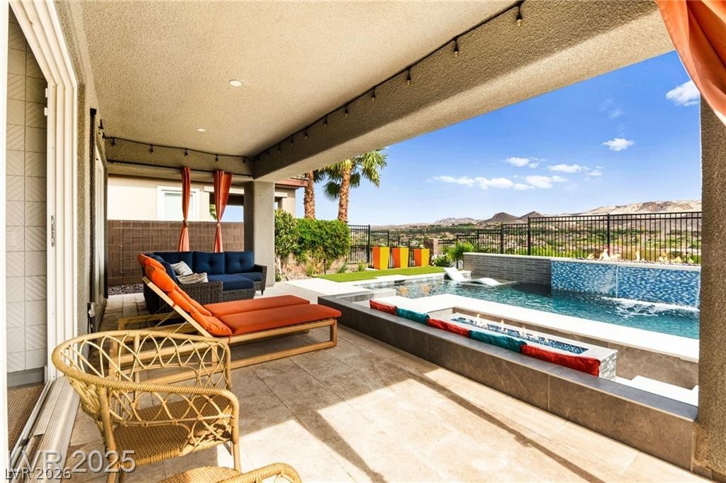 103 Reflection Cove Drive Henderson, NV 89011 - Photo 60 of 66 Fenced backyard with an outdoor hangout area, a patio area, a pool, and a jacuzzi