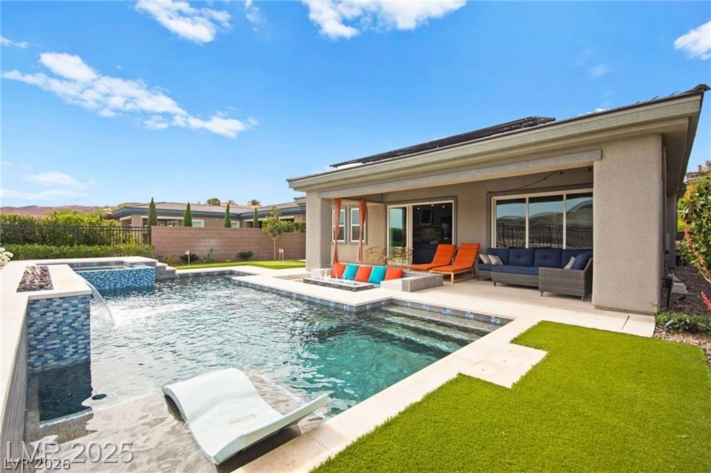 103 Reflection Cove Drive Henderson, NV 89011 - Photo 64 of 66 View of pool featuring a patio area, an outdoor hangout area, a fenced backyard, and a pool with connected hot tub