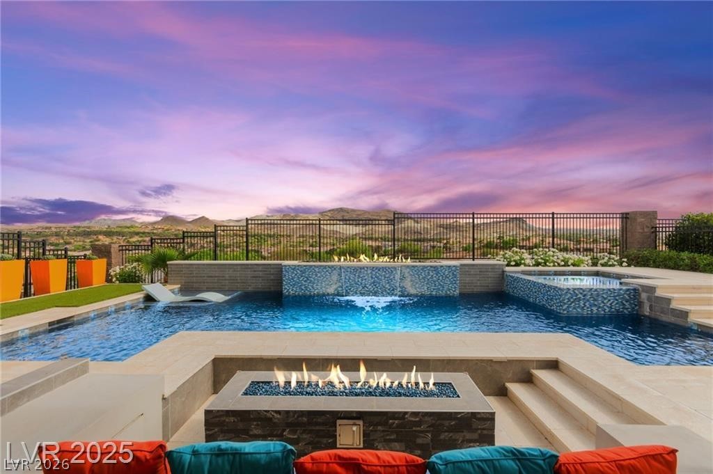 103 Reflection Cove Drive Henderson, NV 89011 - Photo 65 of 66 View of pool with a patio, a fire pit, a fenced backyard, and a pool with connected hot tub