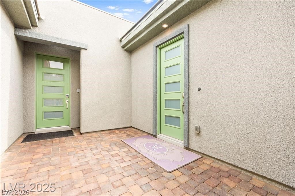 103 Reflection Cove Drive Henderson, NV 89011 - Photo 7 of 66 Entrance to property featuring stucco siding