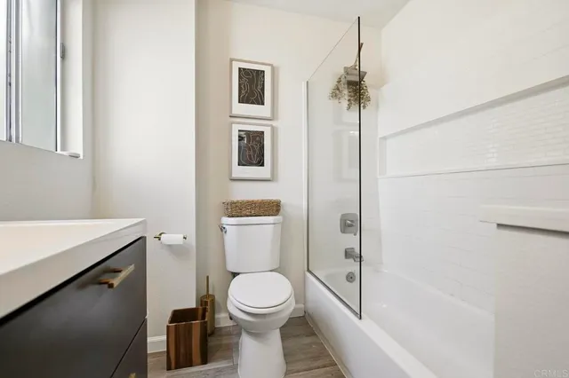 a bathroom with a toilet a sink and shower