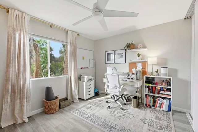 a work room with furniture and a large window