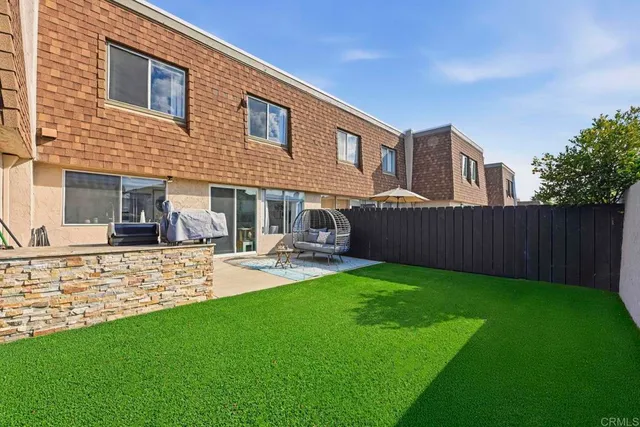 a view of a house with backyard and a slide