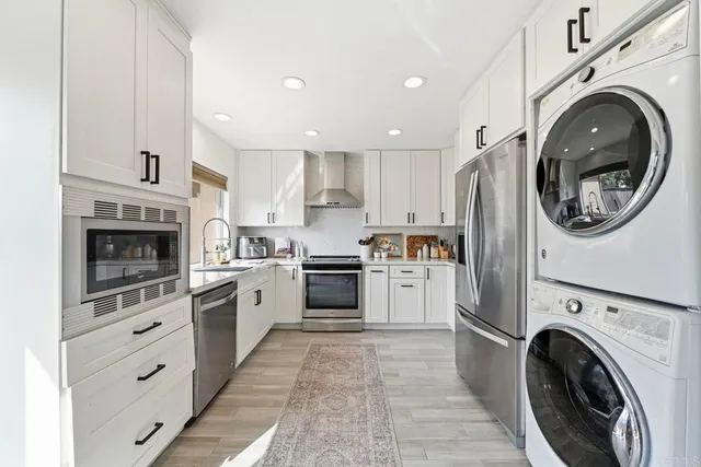 a kitchen with a stove top oven sink and cabinets