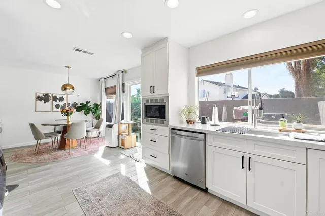 a large white kitchen with a large window
