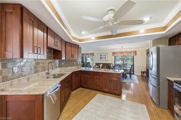 a kitchen with granite countertop a sink appliances and cabinets