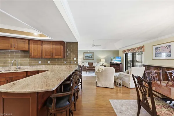 a dining room with furniture and wooden floor