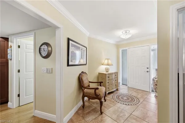 a living room with furniture a clock and a window
