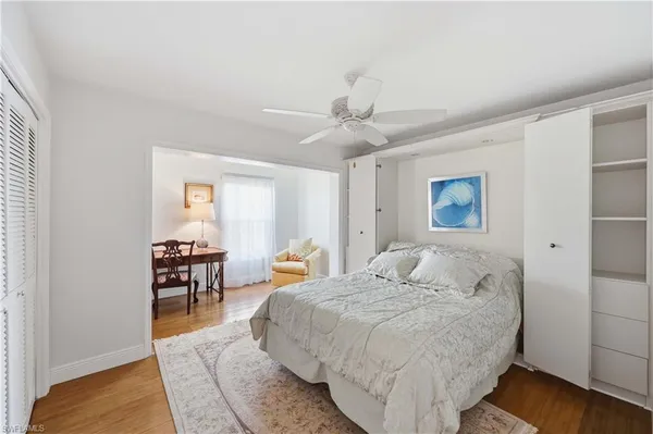 a bedroom with a bed a table and chair