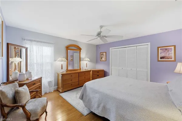 a bedroom with furniture and wooden floor