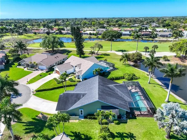 an aerial view of a house with a swimming pool yard and outdoor seating