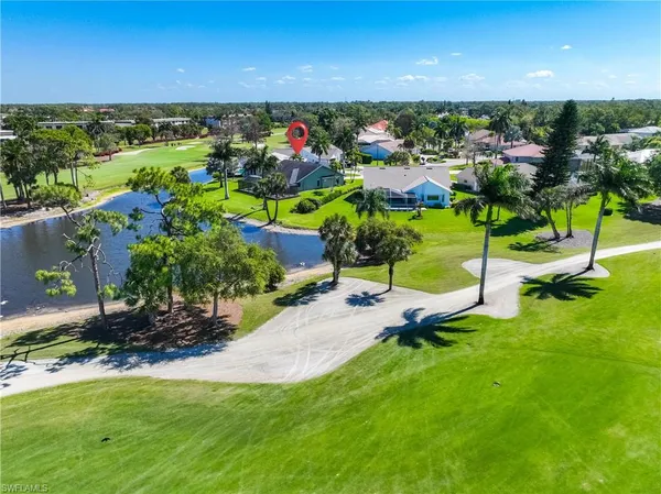 an aerial view of a tennis ground and lake view