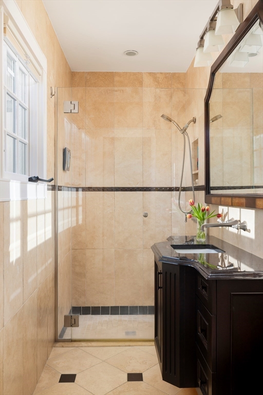 40 Heath Hill Brookline, MA 02445 - Photo 23 of 40 a bathroom with a sink and a mirror