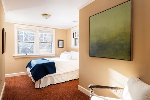 a view of a white house with a swimming pool and a yard in front of it