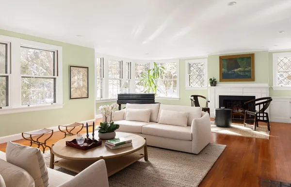 a living room with furniture a fireplace and a flat screen tv