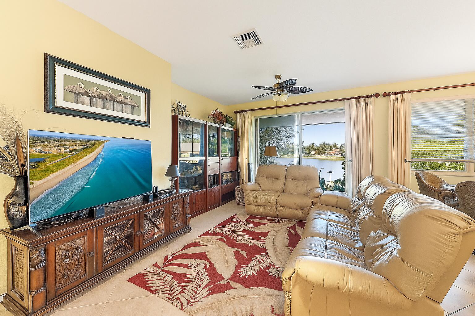 2912 Southwest Porpoise Circle Stuart, FL 34997 - Photo 13 of 36 a living room with furniture and a flat screen tv