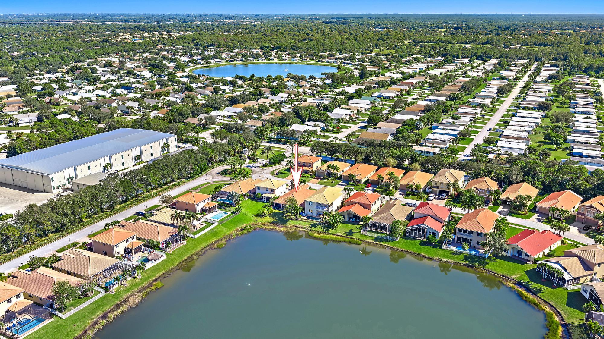 2912 Southwest Porpoise Circle Stuart, FL 34997 - Photo 26 of 36 an aerial view of residential houses with outdoor space and street view